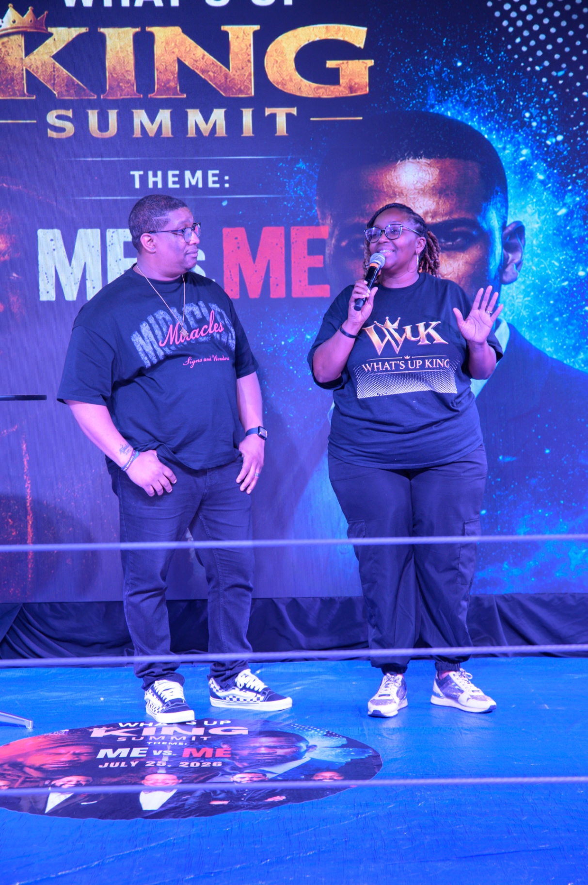 A woman speaking alongside a man on the What's Up King stage